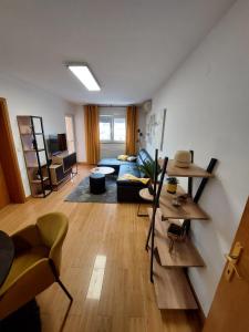 a living room with a couch and a table at Apartman Ares in Osijek