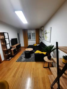 a living room with a couch and a table at Apartman Ares in Osijek