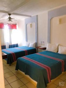 Кровать или кровати в номере Hotel Careyes Puerto Escondido