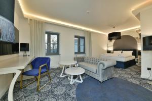 a hotel room with a couch and a bed at Fregata Kołobrzeg in Kołobrzeg