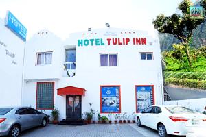 a hotel turnip inn with cars parked in front of it at Hotel Tulip Inn, Gulberg in Lahore