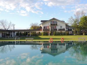 a house sitting next to a large body of water at Vitalpark Blaichach Burgberg in Burgberg