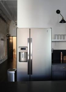 a stainless steel refrigerator in a kitchen at The Grant by Black Swan in Savannah