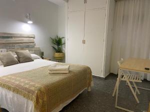 a hotel room with a bed, chair, and table at Hostal Paco Marbella in Marbella