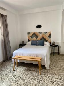 a bedroom with a bed and a dresser at Hostal Paco Marbella in Marbella