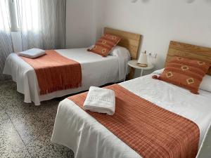 a hotel room with two beds with towels on them at Hostal Paco Marbella in Marbella