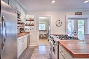 a kitchen with a stove and a refrigerator at Cozy North Charleston Getaway with Fire Pit! in Charleston