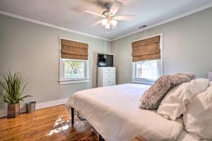 a bedroom with a bed and a ceiling fan at Cozy North Charleston Getaway with Fire Pit! in Charleston
