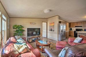 a living room with a couch and a table at Quaint Port OConnor Home Less Than 3 Mi to Beach! in Port O'Connor