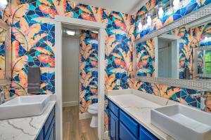 a bathroom with two sinks and a colorful tiled wall at Lake Dayz Granbury Retreat with Private Dock! in Granbury +32 photos