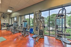 a gym with several tread machines and windows at Idyllic Montgomery Condo with Pool and Lake View! in Montgomery