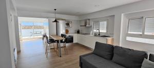 a living room with a couch and a kitchen at AOVE TERRACE in Jaén