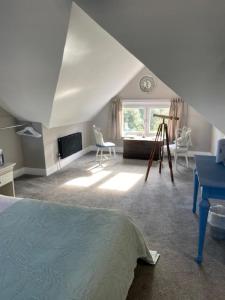 a attic room with a bed and a window at Seaview B&B in Harwich