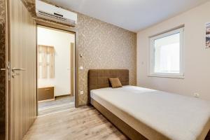 Posteľ alebo postele v izbe v ubytovaní Forest Földvár Apartmanok By BLTN