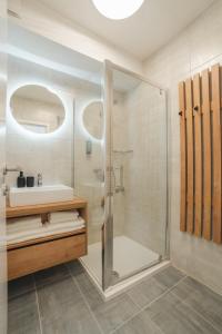 a bathroom with a shower and a sink at St. Martin's Apartments in Grkavešćak