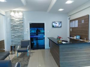 an office with a reception desk and a lobby at Hotel Real Villes in Várzea Grande