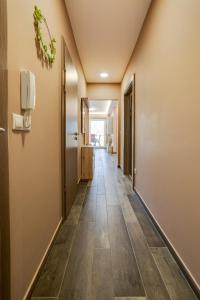 a corridor of a room with wooden floors at Forest Földvár Apartmanok By BLTN in Balatonföldvár