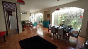 a living room with a table and chairs at Casa do Uai in João Pessoa +60 photos