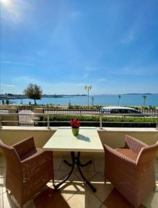 a table and two chairs with a view of the water at Villa Ivana B&B in Zadar