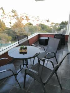 a patio with a table and chairs on a balcony at Apartamento MyR in Benajarafe