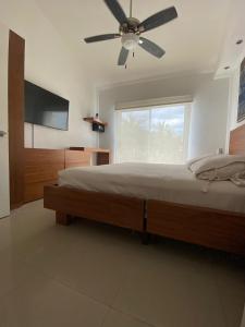 a bedroom with a bed and a ceiling fan at Casa Nuevo Vallarta + 2 albercas in Nuevo Vallarta 