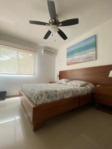 a bedroom with a bed and a ceiling fan at Casa Nuevo Vallarta + 2 albercas in Nuevo Vallarta +13 photos