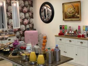 a kitchen with a counter top with food on it at Hotel Restaurant Baryton in Saint-Marcel