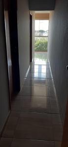 an empty hallway with a window in a building at Recanto Jurandir Marçal in Olímpia