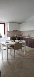 a kitchen with a table and chairs in a room at Casa Panoramica in Orosei