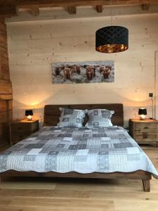 a bedroom with a bed and two night stands at Au Pré des Chevaux in Chateau-d'Oex