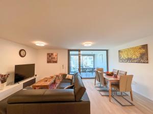 a living room with a couch and a table at Lavish 4.5 rooms furnished apartment @Glattbrugg in Glattbrugg