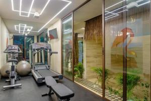 a gym with a treadmill and exercise equipment in a room at Casa Libre - Great for couples 1Br with private pool by StayPodio 408 in Tulum