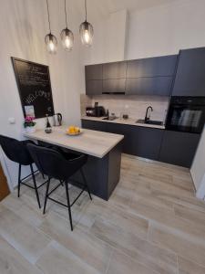 a kitchen with a counter and a table and chairs at Španić palace in Korčula