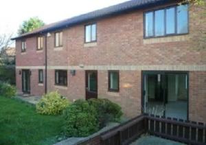 a brick house with a balcony in a yard at 6 Bedroom House For Corporate Stays in Kettering in Kettering