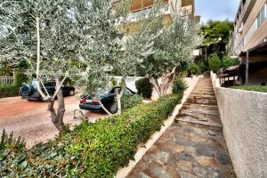 a street with cars parked next to a building at Villasonboard Vouliagmeni Condo Lux & Comfy Riviera & beach in Athens