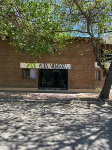 a building with a sign on the side of it at Hotel Alta Mendoza in Mendoza