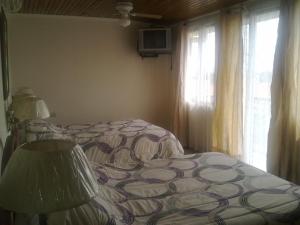 Postel nebo postele na pokoji v ubytování Hotel La Guaria Inn & Suites