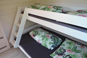 two bunk beds in a small room with two pillows at holiday home, Kolczewo in Kołczewo