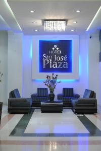 a waiting room with couches and a blue wall at Hotel San José Plaza in Bucaramanga