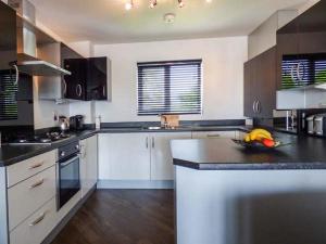 a kitchen with a bowl of fruit on a counter at Tehidy in Charlestown