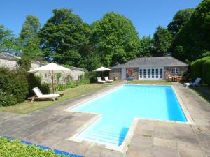 a swimming pool in the backyard of a house at Parlour Cottage in Saint Erth