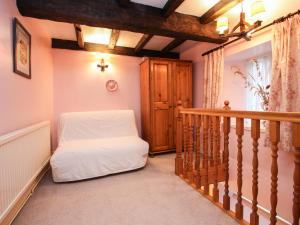 a room with a staircase with a white bed at Miller's House in Tintagel