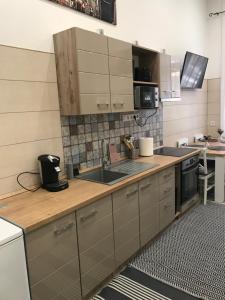 a kitchen with a sink and a counter top at Móra apartman 2 in Kiskunfélegyháza