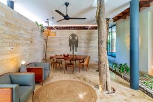 a dining room with a table and chairs at Casa Libre - Incredible huge condo with private pool and terrace in Aldea Zama by StayPodio 301 in Tulum