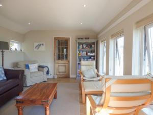 a living room with a couch and a table at Pretoria in Coverack
