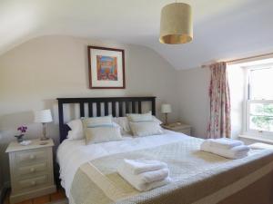 a bedroom with a large bed with towels on it at Pretoria in Coverack