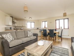 a living room with a couch and a table at Sea Spray in Marazion