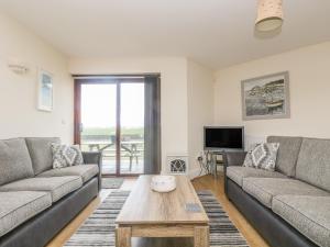 a living room with two couches and a coffee table at Sea Spray in Marazion