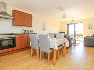 a kitchen and dining room with a table and chairs at Seashells in Marazion