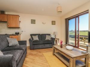 a living room with a couch and a table at Surfside in Marazion